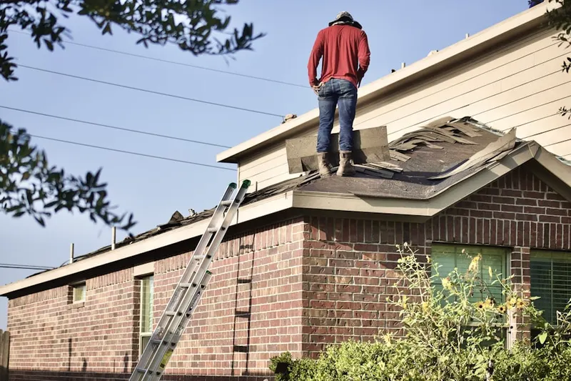 Professional roofer working on a residential roof in Patrick Afb